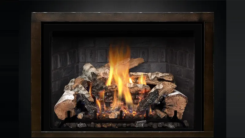 A Mendota gas insert with a birch log fire burning inside a bronze frame